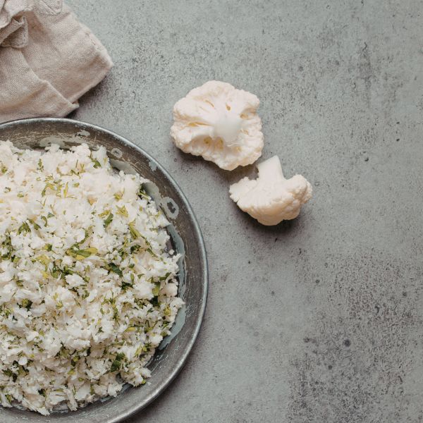 Fresh cauliflower vegetable from Local Market, single whole cauliflower head with green leaves in a natural setting