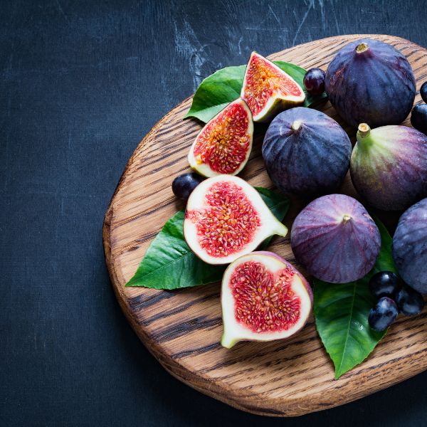 Fresh black figs from Taif in a 1 kg pack, shown in a natural setting, showcasing their ripe, plump appearance.