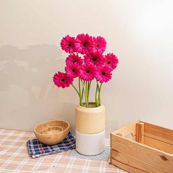 Bouquet of 10 vibrant Gerbera Beth flowers from Flowranow arranged in a clear vase on a white background.