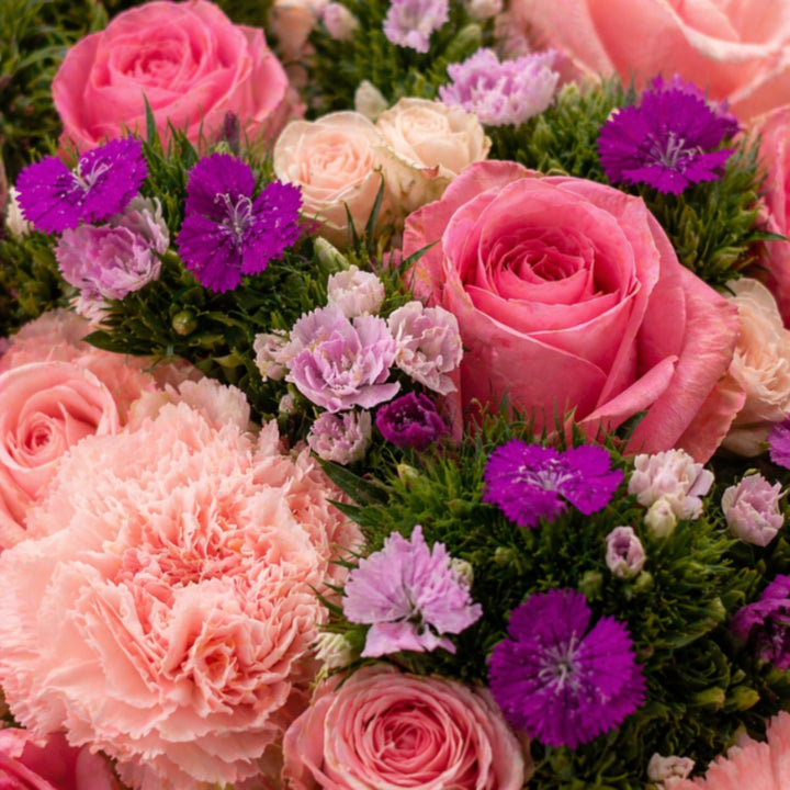 Pinkish mixed bouquet with 15 stems of assorted flowers from Black Tulip, arranged in a vibrant, natural display.