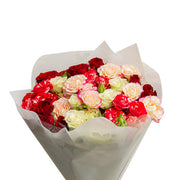 Pink Whisper Bouquet with 12 stems of mixed pink flowers, showcasing vibrant blooms and lush greenery in a floral bouquet.