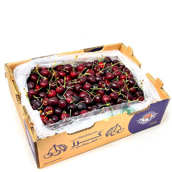 Fresh red cherries in a 5 kg carton by Sharbatly, showcasing ripe, glossy fruit ready for consumption.